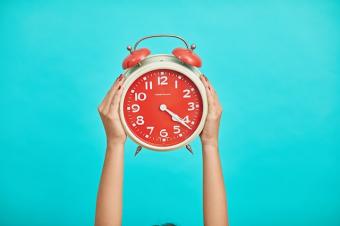 Red alarm clock on blue background